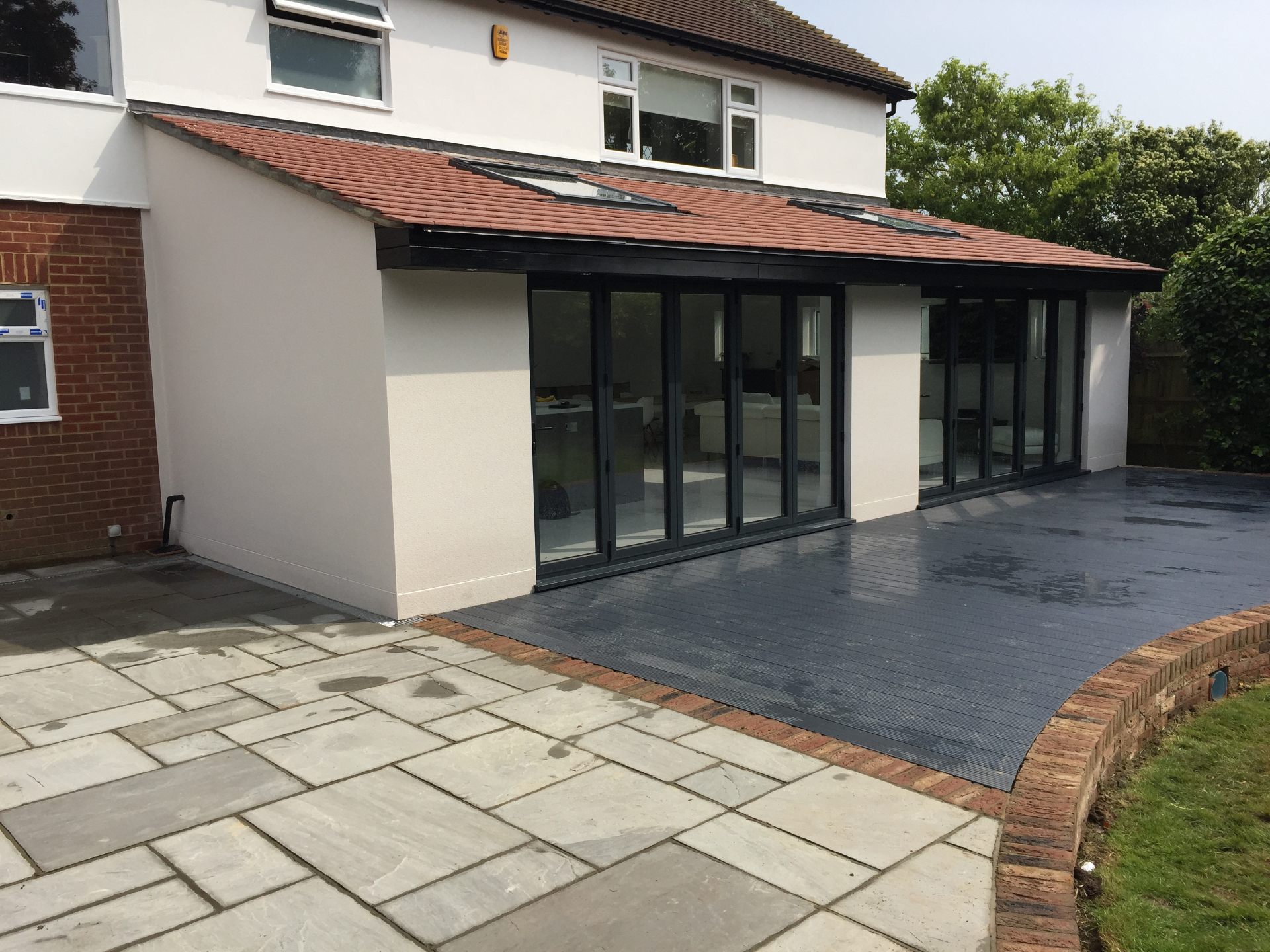 Rear extension with composite decking and patio in Eastbourne