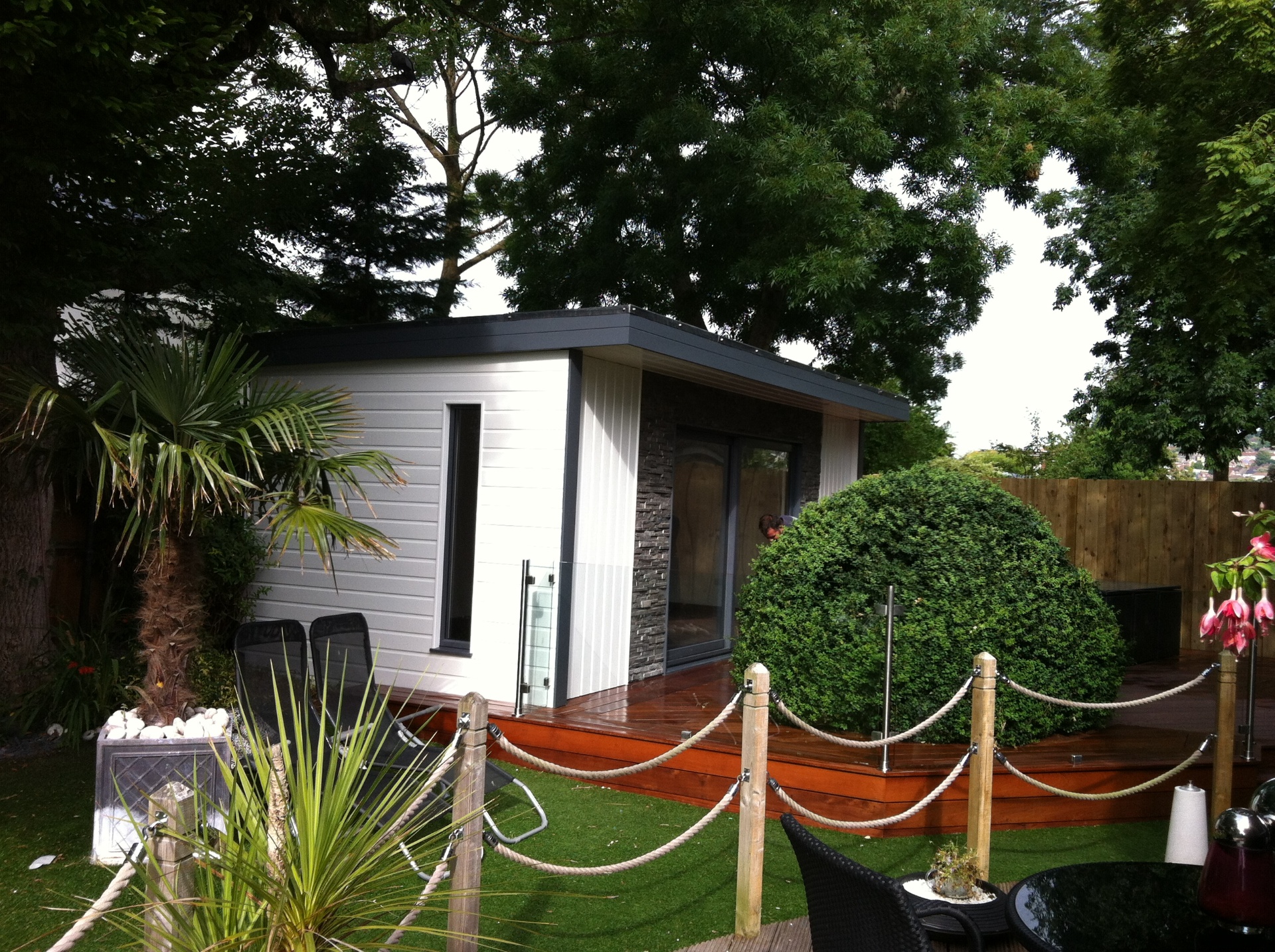 Garage conversion with French doors and composite decking terrace