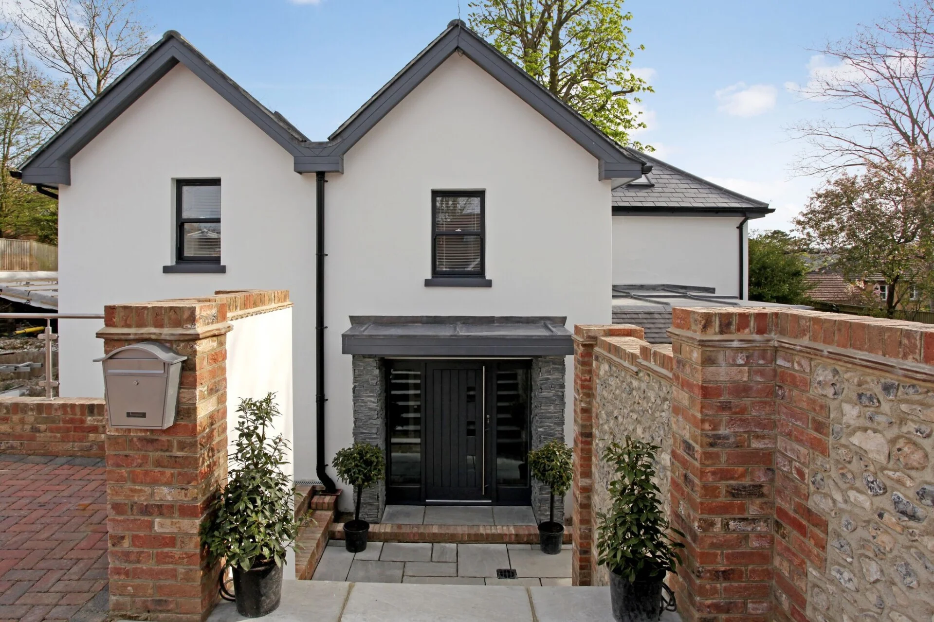 New build front entrance with stone cladding and contemporary door design