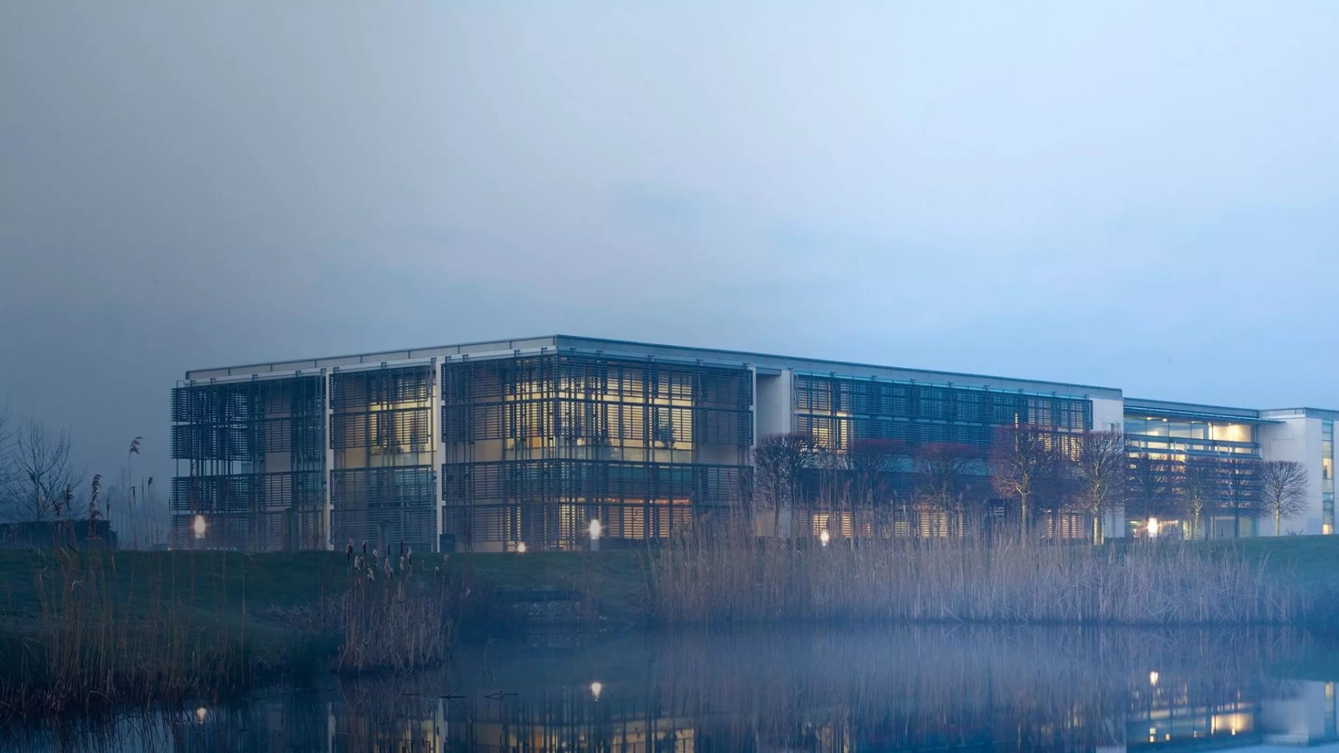 Rolls-Royce Goodwood factory exterior at dusk with reflections on water